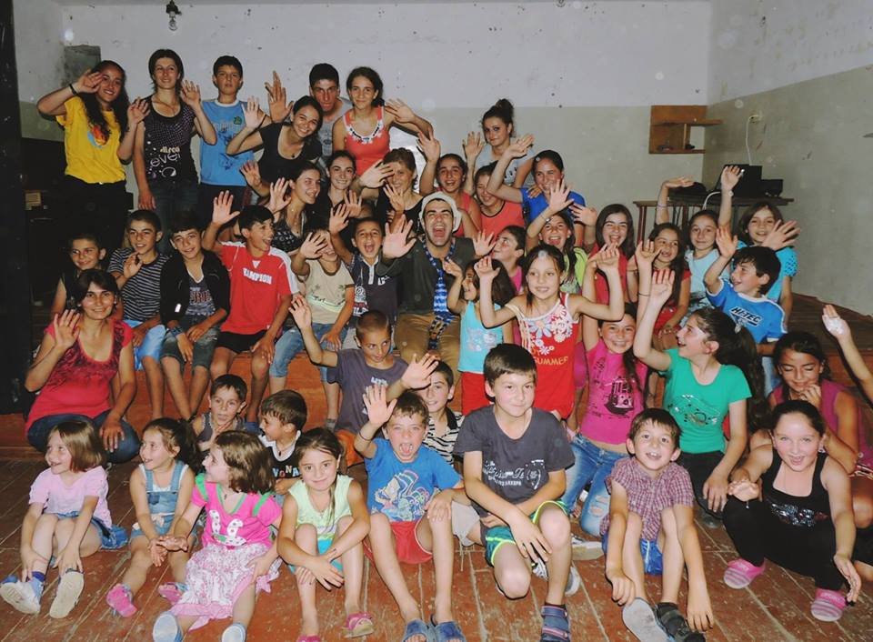 Children and volunteers together during a books and magic visit to a remote community