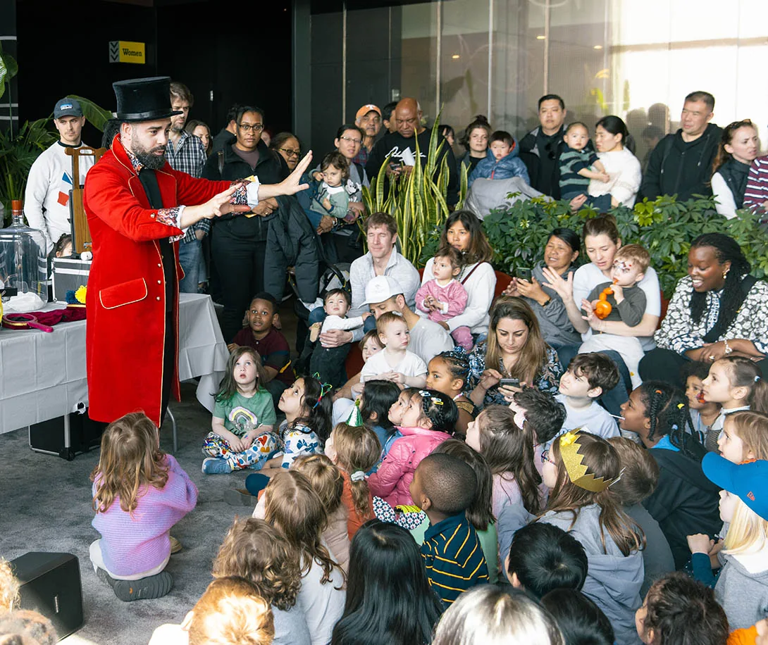 Nico performing magic for children and parents at an indoor family event