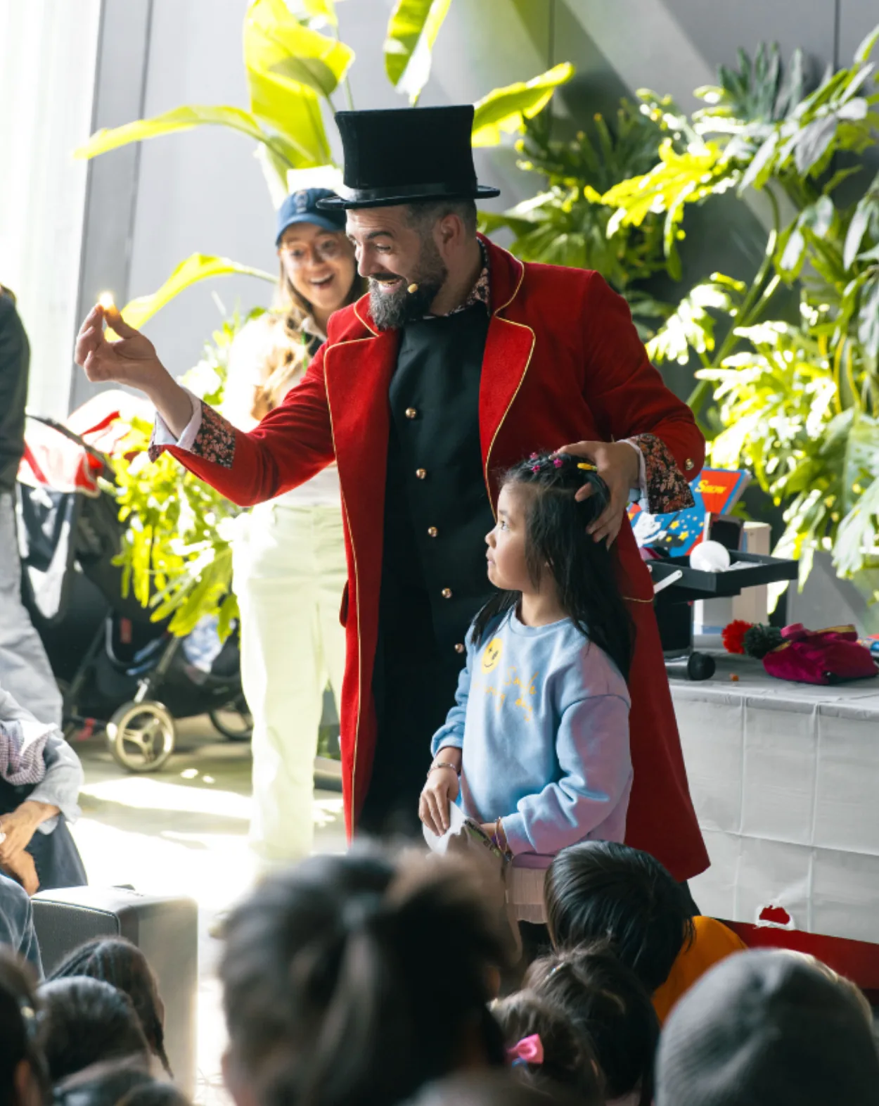 Nico, the Magic For Kids NYC party magician, performing with a child